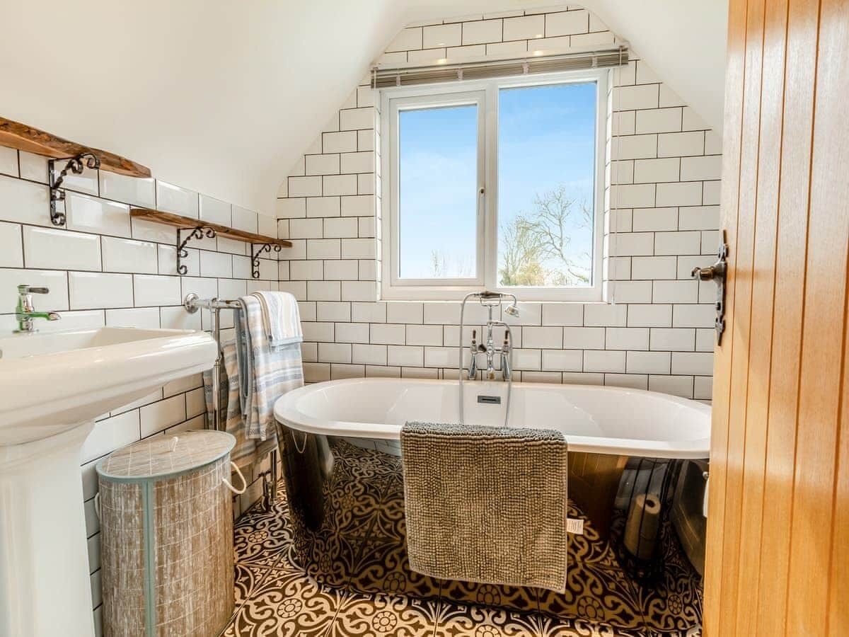 A bathroom with a bathtub, a toilet, and a sink.