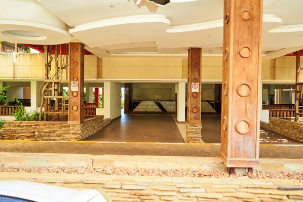 A spacious indoor area with a high ceiling, stone pillars, and a central open space.