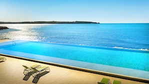 A pool with a view of the sea, surrounded by lounge chairs. - Aminess Planet Camping Holiday Homes Sirena (Novigrad)