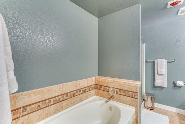 A bathroom with a bathtub, a shower, and a tiled floor. - Private Cabin w/ Forest Views & Grill in Lakehead! (Lakehead)