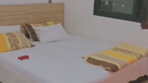 A bedroom with a bed, wooden headboard, and a window. - Furnished studio in DAKAR quiet in a building with security and comfort assured (Dakar)