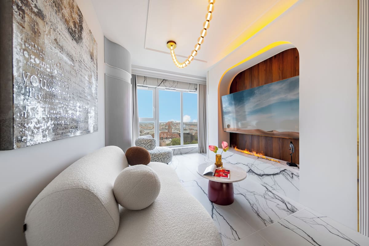 Ein modernes Wohnzimmer mit einer Couch, einem Marmortisch und einem großen Gemälde an der Wand.