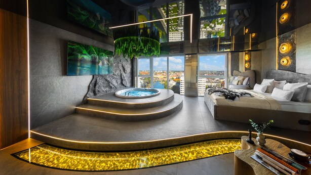 A modern interior with a circular hot tub, a bed with a view, and a large window. - Quorum Apartments (Wroclaw)