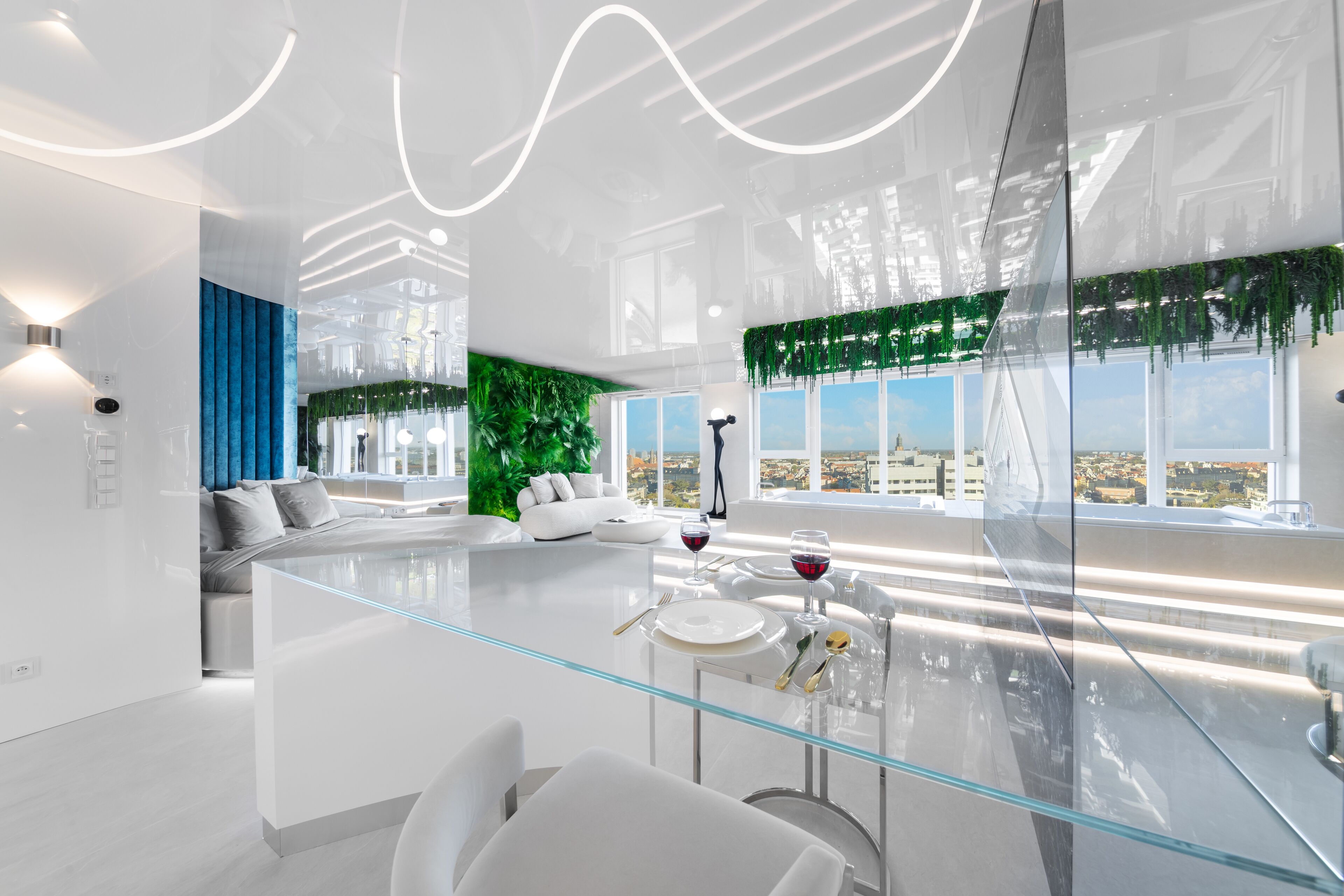 A modern dining area with a glass table, white chairs, and a city view.