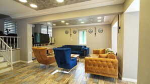 A spacious living area with a blue sofa, a yellow armchair, and a wooden coffee table. - Yeşil Panjurlu Villa Otel (Bursa)