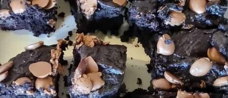 A tray of brownies with chocolate chips on top.