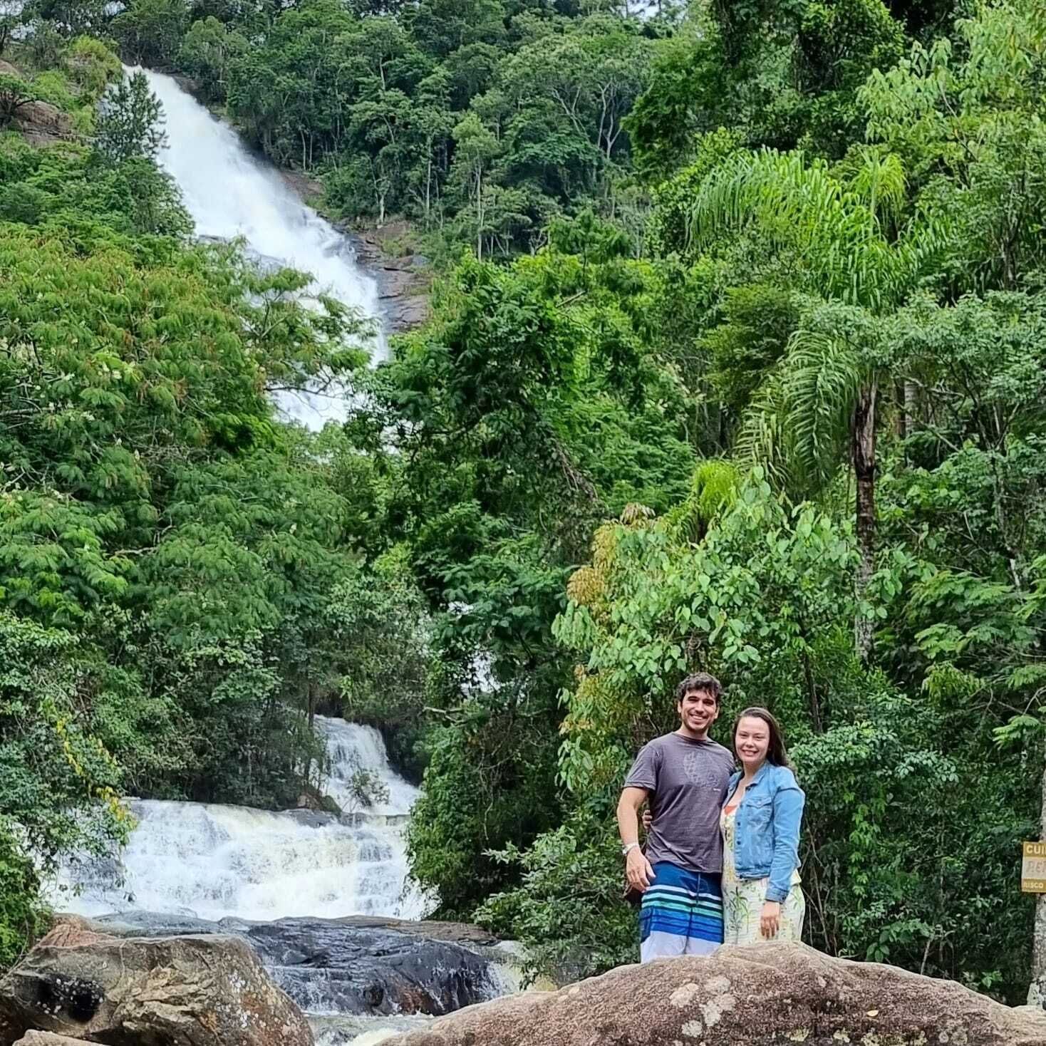 A waterfall in a lush forest setting.