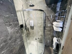 Shower, hair dryer, towels, shampoo