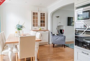 Enjoy meals in this well-equipped kitchen with a dining table and cabinet.