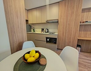 A modern kitchen with wooden cabinets, a built-in microwave, and a coffee maker.
