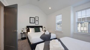A hotel room with two beds, a large window, and a door. - Beautiful Townhomes! Two Units With Outdoor Patios (Nashville)