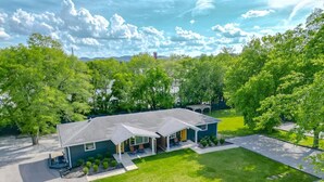 A two-story house with a covered porch, a front yard, and a driveway. - Pretty & Bright - Historic Franklin Quadplex (Franklin)