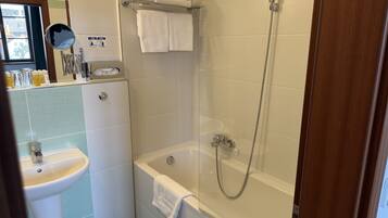 A bathroom with a sink, a bathtub, and a shower.