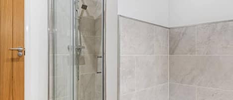 Shower, hair dryer, towels, shampoo