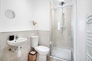 Shower, hair dryer, towels, shampoo