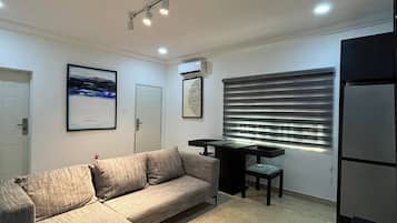 Family Apartment, Balcony, City View | Living area | Flat-screen TV