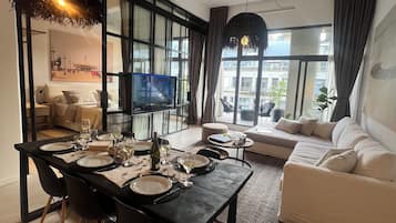 Deluxe Apartment, 3 Bedrooms, Balcony, Pool View | Living area | 42-inch Smart TV with cable channels, Netflix, pay films