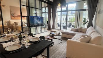 Deluxe Apartment, 3 Bedrooms, Balcony, Pool View | Living area | 42-inch Smart TV with cable channels, Netflix, pay films