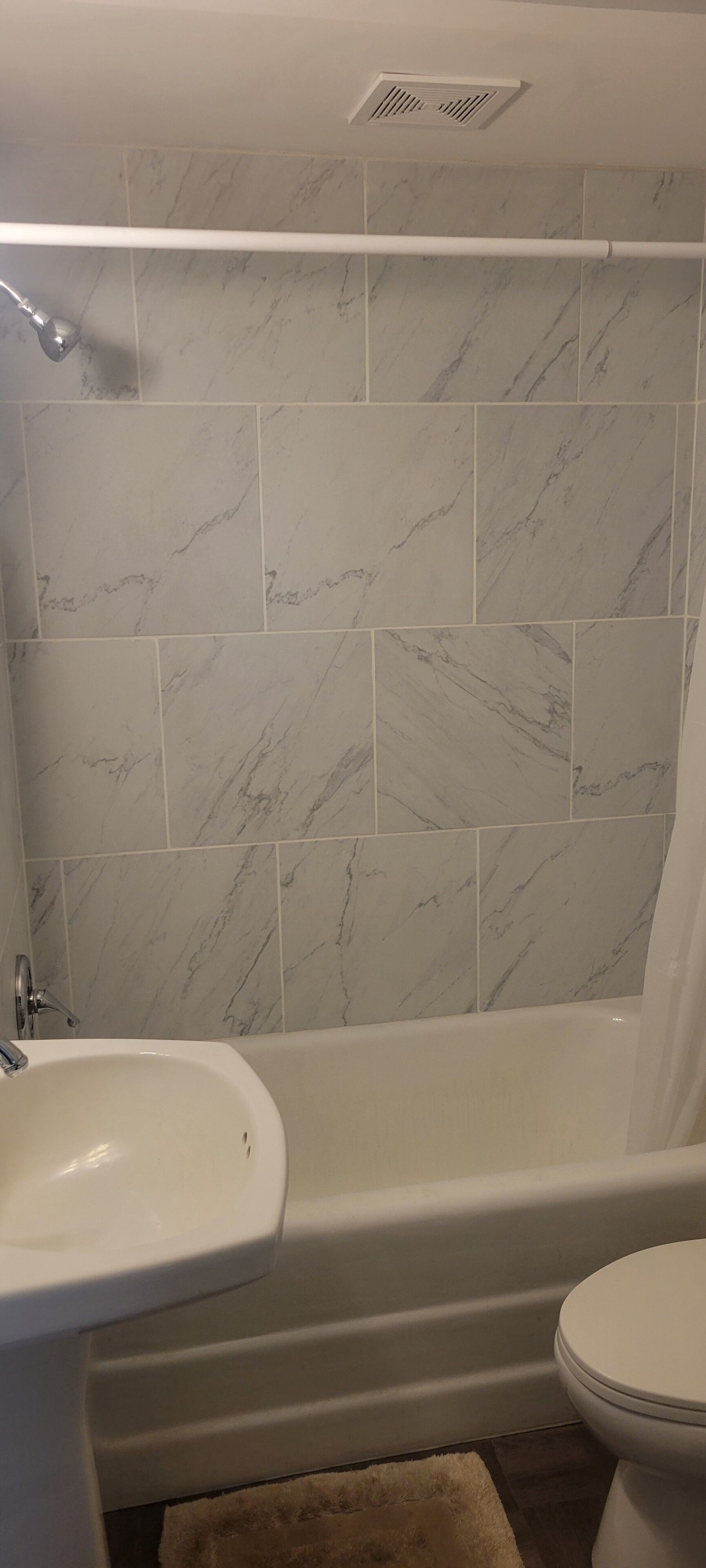 A bathroom with a bathtub, a sink, and a toilet.