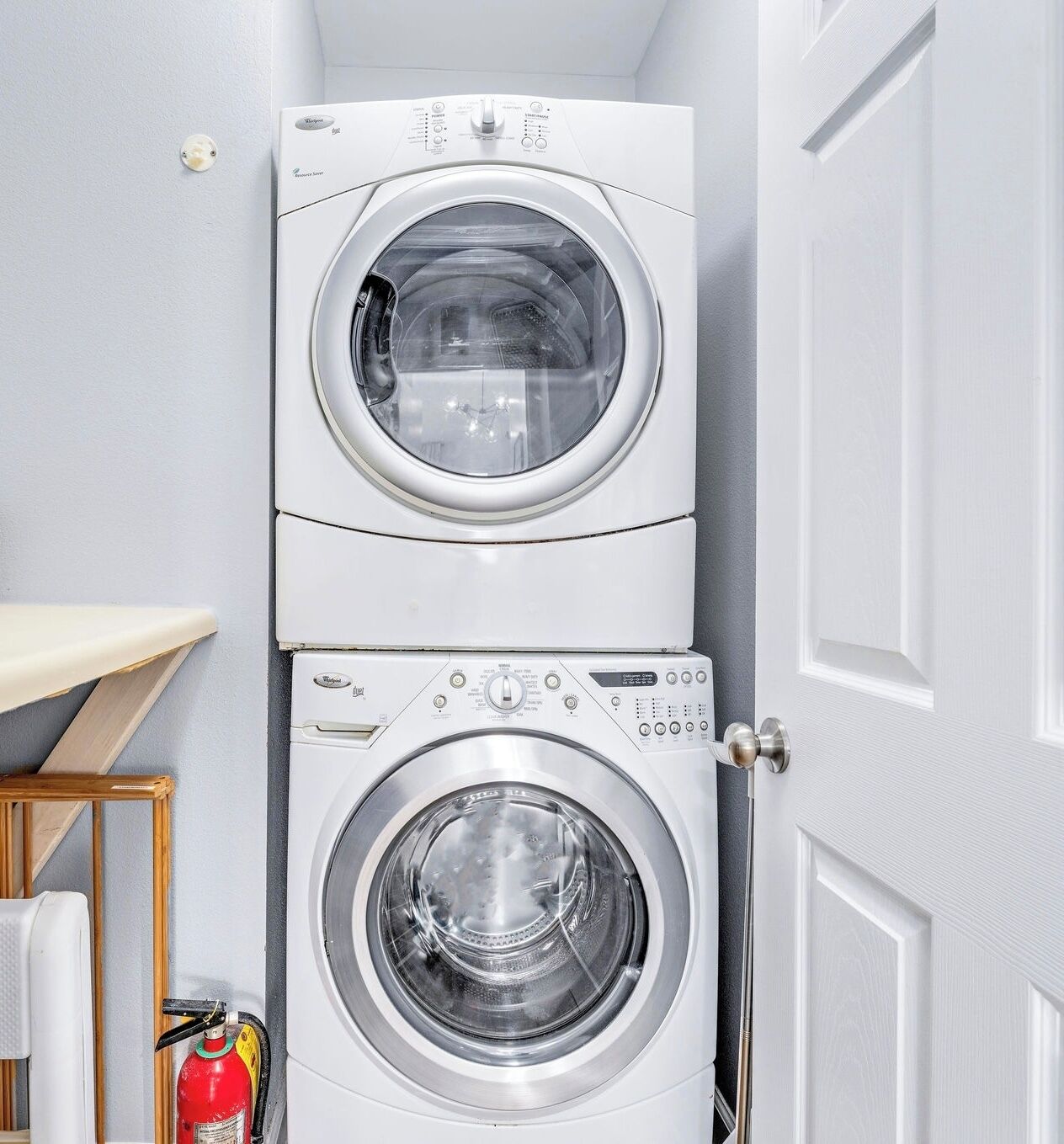 A laundry room with two stacked front-loading washing machines.