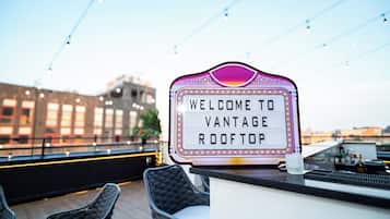 A rooftop bar with a sign reading "Welcome to Vantage Rooftop."