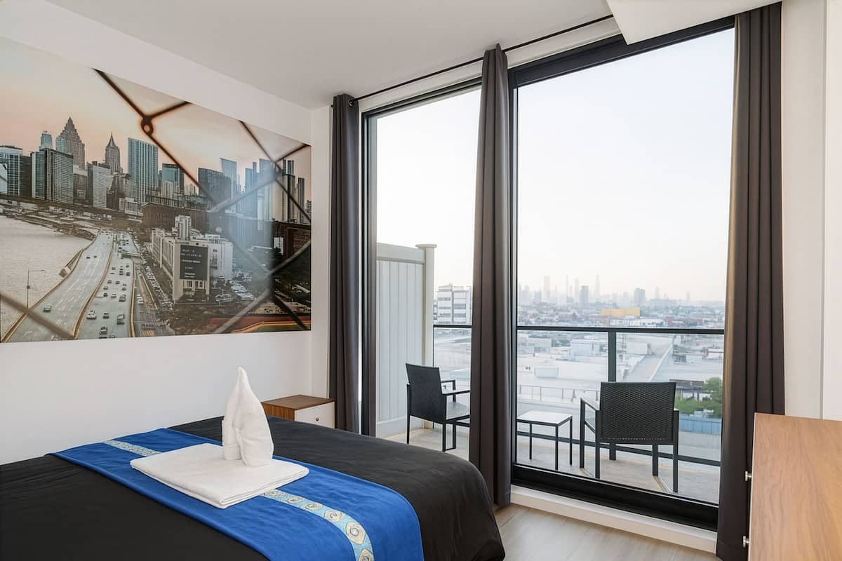 Deluxe Room, Balcony | 1 bedroom, desk, laptop workspace, iron/ironing board