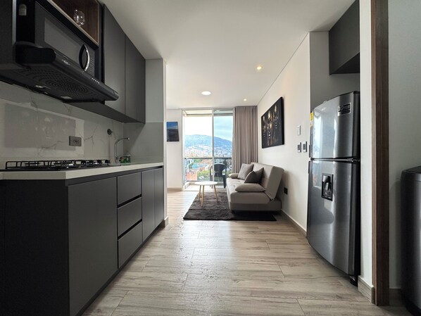 Deluxe Studio, 1 Bedroom, Balcony, City View | Private kitchen | Full-size fridge, microwave, stovetop, dishwasher