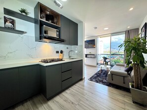 Deluxe Studio, 1 Bedroom, Balcony, City View | Private kitchen | Full-sized fridge, microwave, stovetop, dishwasher - Torre Zurich Luxury  (Medellín)