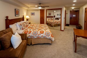 Cozy retreat with a large bed, wooden headboard, and comfortable sofa.