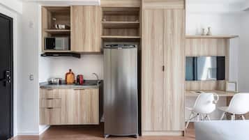 A modern kitchen with a built-in refrigerator, microwave, and stove.