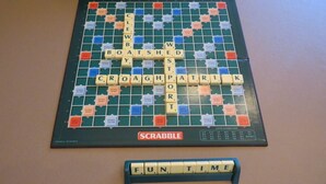 Un plateau de jeu de Scrabble avec les lettres formant le mot « FUN TIME » disposées sur le présentoir.
