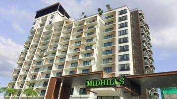 A multi-story hotel building with a prominent entrance and signage.