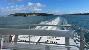 A boat's deck with a sign indicating a man overboard rescue sling and a lifebuoy.