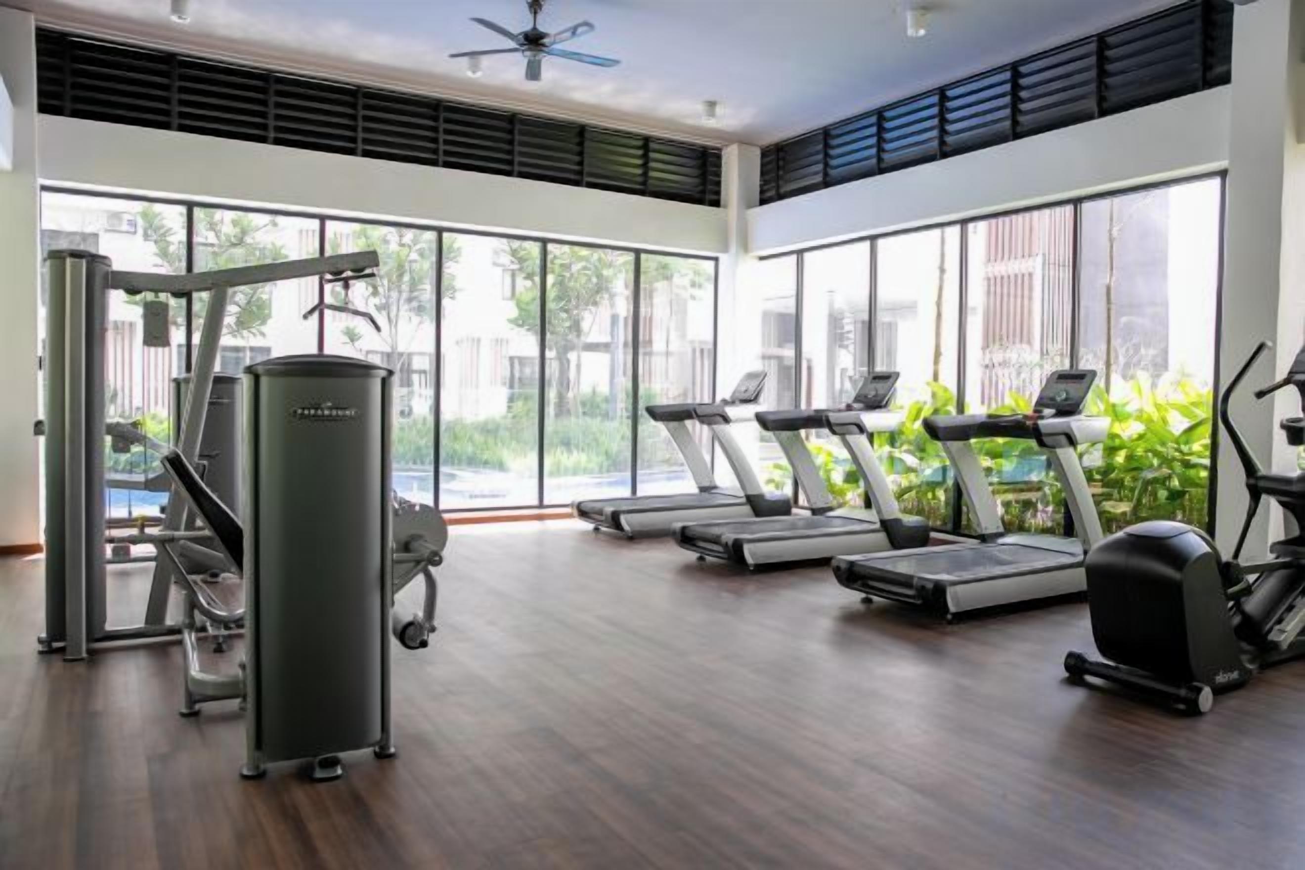A gym with treadmills, a stationary bike, and a weight machine.