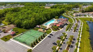 An aerial view of a residential area with a swimming pool, tennis courts, and a parking lot. - NEW - Spacious 4-bedroom near Bethany Beach in Bishops Landing resort + shuttle (Millville)