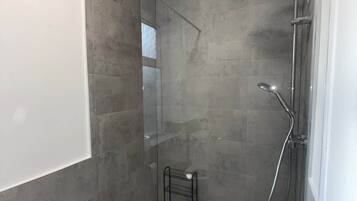 Shower, hair dryer, soap, toilet paper