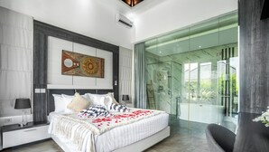 A modern bedroom with a large bed, a glass shower enclosure, and a view of the outdoors. - Villa Liamax (By JB Villas) (Bali)