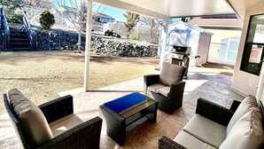 An outdoor patio with wicker furniture, a blue table, and a covered area. - Spacious Prescott Home w/Fenced Yard & Central Loc (Prescott)