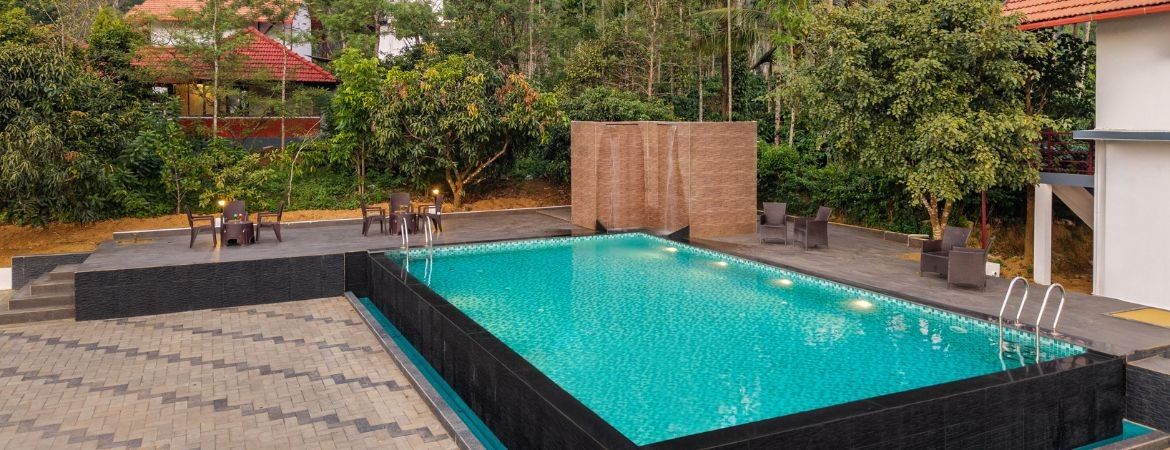 A rectangular swimming pool with a black border and a tiled deck area.