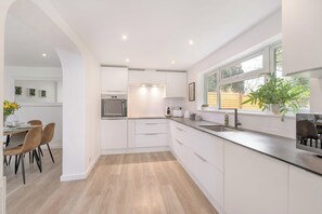 Enjoy meals in the kitchen with a dining area and large window offering a view of the outdoors.