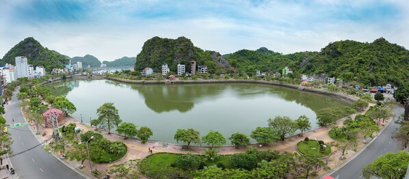 Un cuerpo de agua grande y circular rodeado de vegetación y edificios.