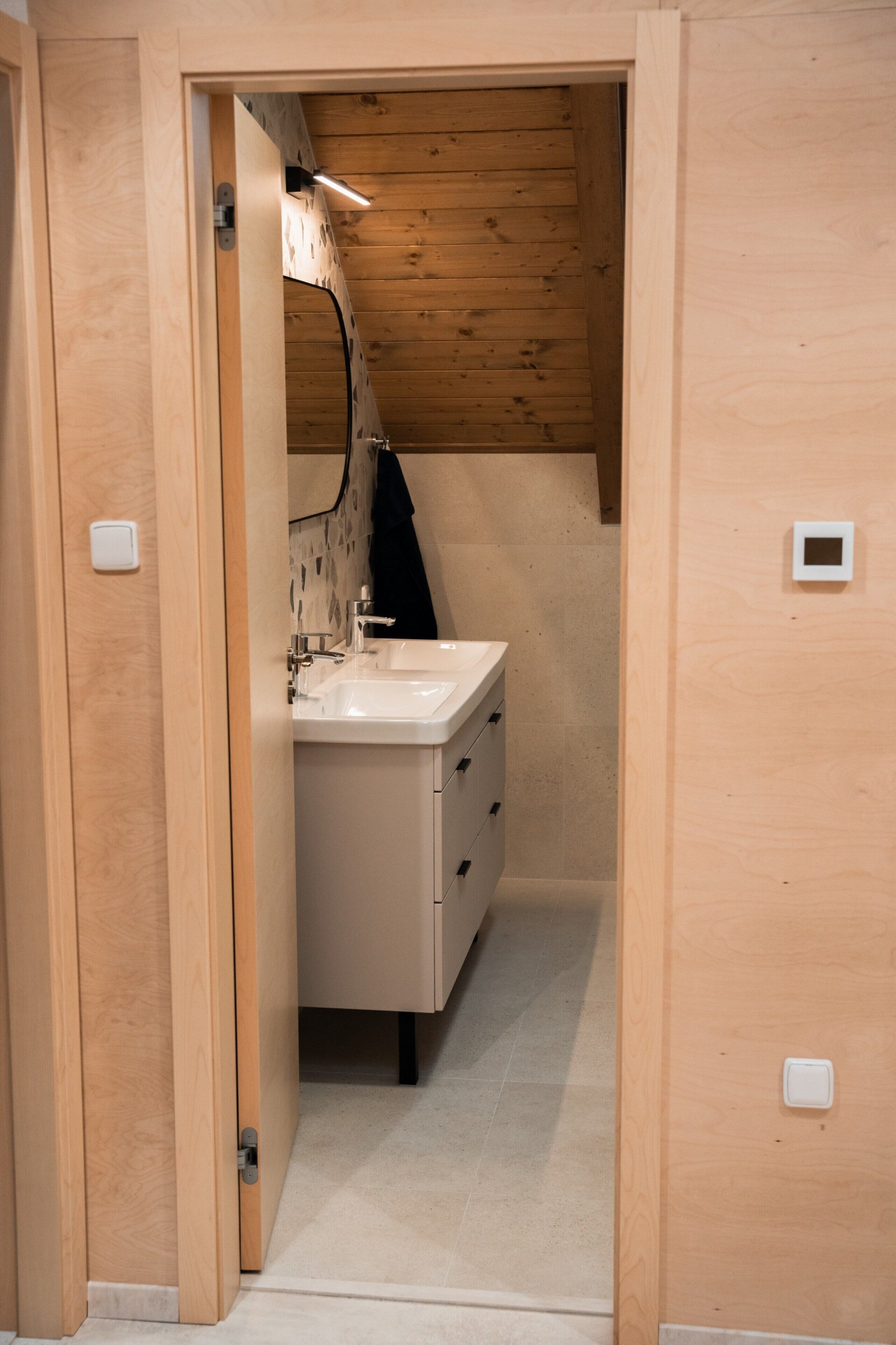 A wooden-paneled bathroom with a sink and cabinets.