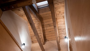 A wooden interior with a sloped ceiling, two doors, and a skylight. - Villa in Jeseniky With Sauna & Mountain Views (Bela pod Pradedem)