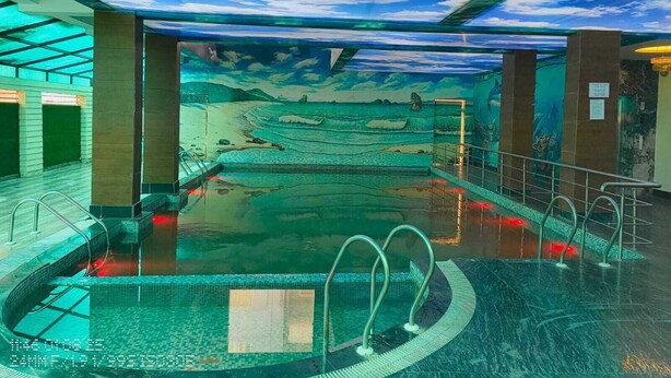 An indoor swimming pool with a mural of a beach scene on the ceiling. - HOTEL MANNAT INTERNATIONAL (Kanthi)