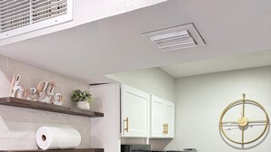 A modern kitchen with white cabinets, a stainless steel sink, a black microwave, and a black refrigerator. - NEW Central Buckhead Apt Atlanta Gem (Atlanta)