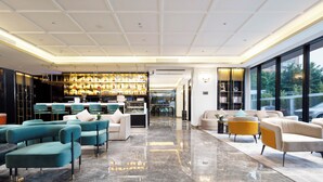 A spacious lobby with a high ceiling, a bar area with shelves of bottles, and seating arrangements. - Pazhou XANA Deluxe International Hotel Pazhou Convention and Exhibition Center Nanzhou Subway Metro Branch - Free Shuttle Bus to Canton Fair Complex During Canton Fair Period (Guangzhou)