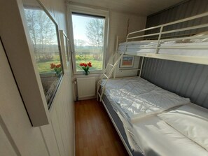 A bunk bed room with a window, a radiator, and a framed picture on the wall. - Holiday Retreat in Sint Maartenszee (Sint Maartensvlotbrug)