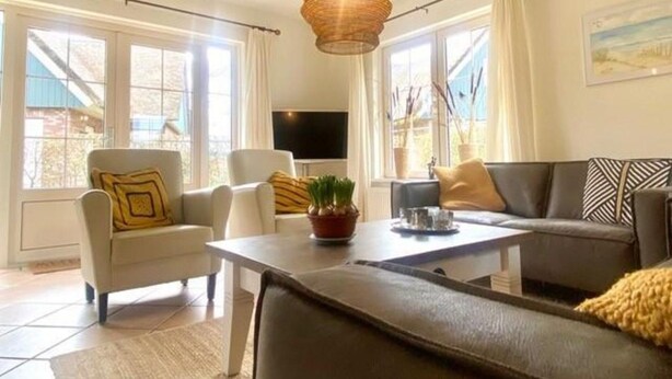 A modern living room with a sofa, armchairs, a coffee table, and a television. - Attractive Villa Close to Forest, Beach, sea (Sint Maartensvlotbrug)