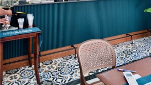 A bar area with a teal counter, hanging wicker lights, and a decorative ceiling. - MARCO'S INTERLUDE Hotel Phu Quoc (Phu Quoc)