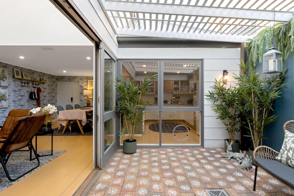 Sliding doors open out onto private indoor courtyard